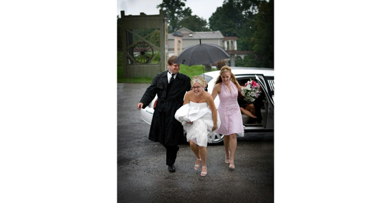 Brentwood chauffeur assisting a wedding couple.
